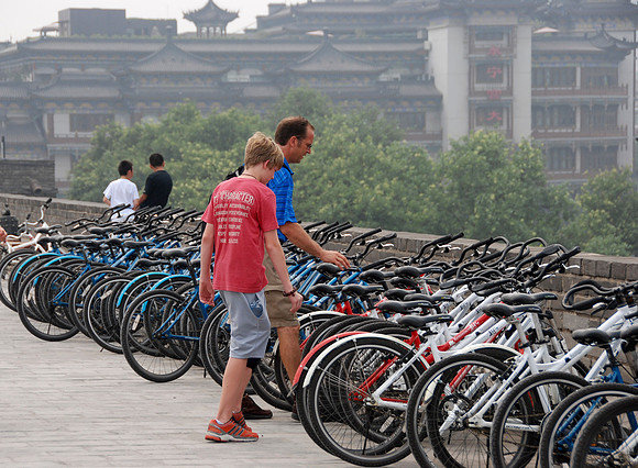 Choosing bikes to ride along the top of the wall.