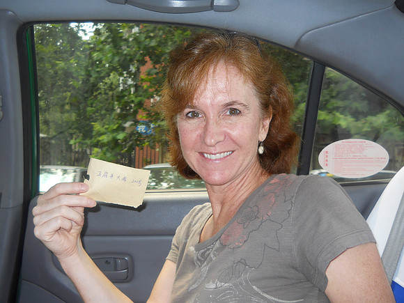 I'm holding a precious scrap of paper.  It tells our taxi driver where to take us.
