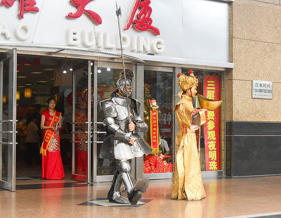 Two costumed guys trying to draw customers to this store.