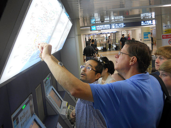 Atsunori shows Jim the subway map.