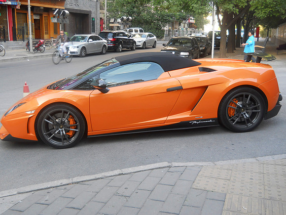 Orange Lamborghini outside the famous dumpling place.