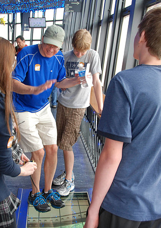 Jim pretending to be scared to step onto the glass floor.