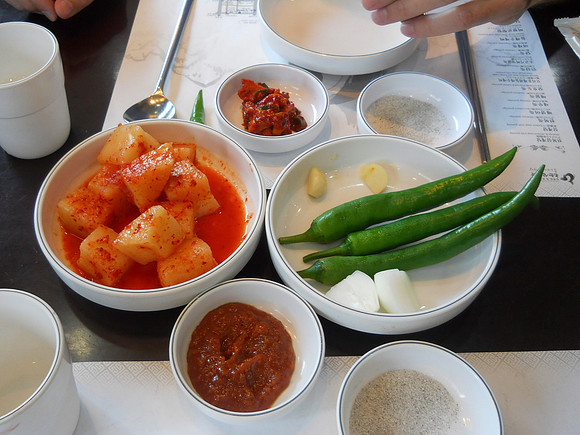 At every Korean meal, they always bring these items.  Very spicy peppers and a salad thing.