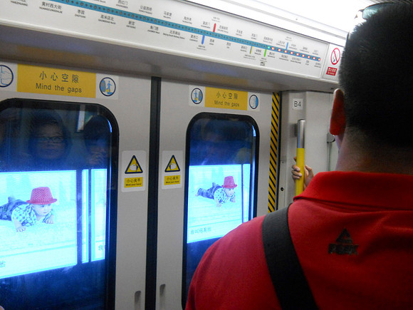 They show video on the walls of the subway tunnels outside the train windows.