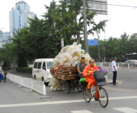 Blurry photo, but we had to share how the trash collectors get around!  He has plastic gallon jugs.