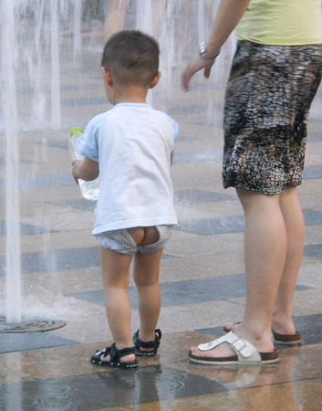 We see toddlers just "going" where they stand or next to a tree in the sidewalk.