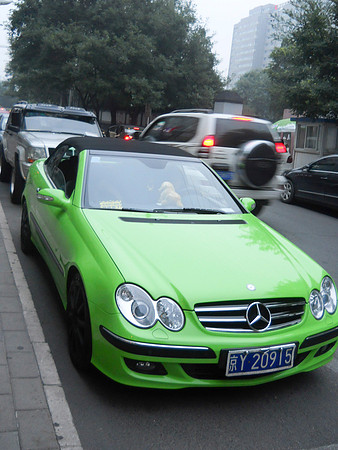Very bright neon green Mercedes parked outside of Jason's favorite restaurant.